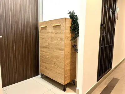 a wooden locker in a hallway next to a door at M Vertica, Sunway Velocity Kuala Lumpur by Rverse Suite in Kuala Lumpur