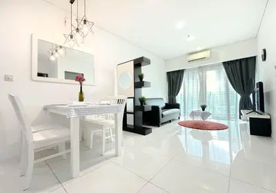 a white living room with a white table and chairs at Summer Suites KLCC by apartx in Kuala Lumpur