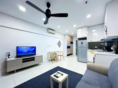 a living room with a couch and a ceiling fan at Summer Suites KLCC by apartx in Kuala Lumpur