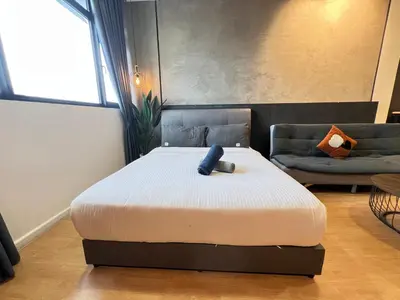 a bedroom with a bed and a couch at Chambers Residence by Gloria Homes in Kuala Lumpur