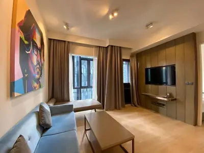 a living room with a blue couch and a tv at Star Resident KLCC By M&T in Kuala Lumpur