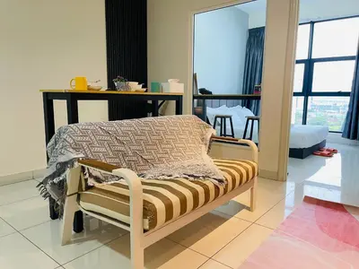 a bedroom with a bed in a room with a table at Arte Mont Kiara by DeUrban in Kuala Lumpur