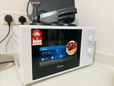 a microwave with a picture of a pizza at Arte Mont Kiara by DeUrban in Kuala Lumpur