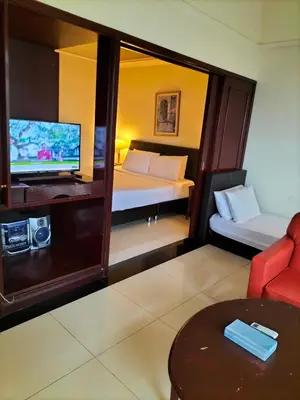 a room with a bed and a tv and a couch at Bukit Bintang Service Suite at Times Square in Kuala Lumpur