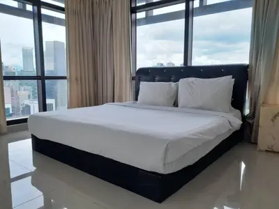 a large bed in a room with large windows at Bukit Bintang Service Suite at Times Square in Kuala Lumpur