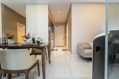 a dining room with a table and a couch at Dorsett Residences Sri Hartamas 5 Star Suites KL in Kuala Lumpur