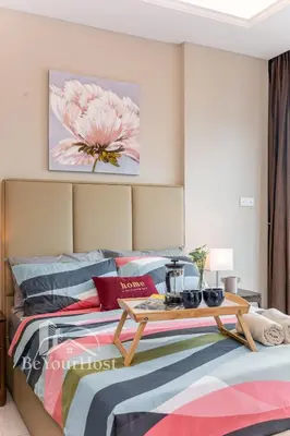 a bedroom with a bed with a table on it at Dorsett Residences Sri Hartamas 5 Star Suites KL in Kuala Lumpur