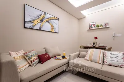a living room with a couch and a table at Dorsett Residences Sri Hartamas 5 Star Suites KL in Kuala Lumpur