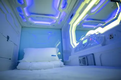 a room with a bed and lights in an airplane at Space Hotel KL Sentral in Kuala Lumpur