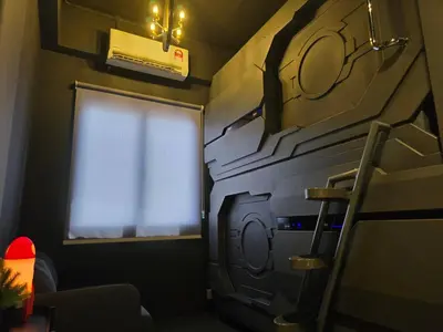 a small room with a window and a stove at Space Hotel KL Sentral in Kuala Lumpur