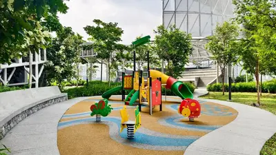 a playground in a park in front of a building at Premium Skyscraper 1 Bedroom Suite in KL 1-3pax in Kuala Lumpur