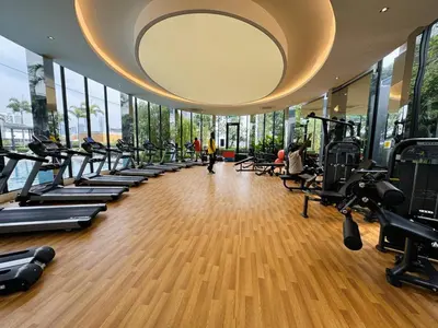 a gym with tread machines and a large mirror at Premium Skyscraper 1 Bedroom Suite in KL 1-3pax in Kuala Lumpur