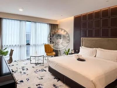 a bedroom with a large bed and a desk and a chair at HOME STYLE at Platinum Suites 2 KLCC Twin Towers in Kuala Lumpur
