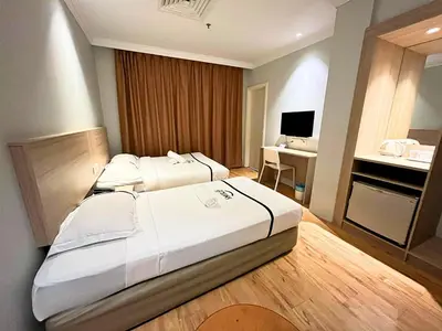 a hotel room with a large bed and a desk at Sky Hotel Chow Kit PWTC in Kuala Lumpur