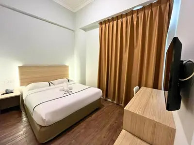 a bedroom with a bed and a tv in a room at Sky Hotel Chow Kit PWTC in Kuala Lumpur