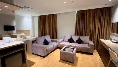 a living room with two couches and a tv at Sky Hotel Chow Kit PWTC in Kuala Lumpur