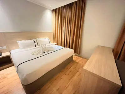 a hotel room with a bed with a bow on it at Sky Hotel Chow Kit PWTC in Kuala Lumpur