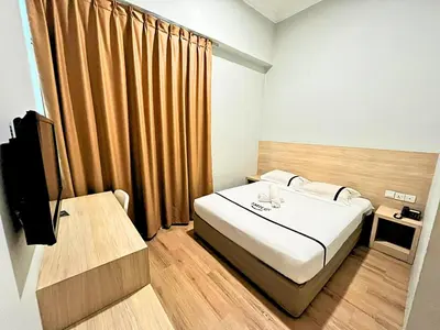 a hotel room with a bed and a television at Sky Hotel Chow Kit PWTC in Kuala Lumpur