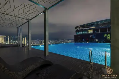 a view of a swimming pool at night at The Manor Residence KLCC by Five Senses in Kuala Lumpur