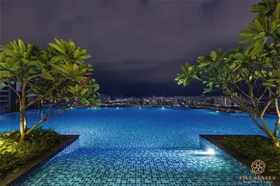 a swimming pool with a city skyline in the background at The Manor Residence KLCC by Five Senses in Kuala Lumpur