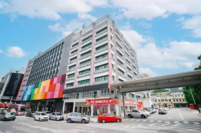 a large building with cars parked in front of it at Kingston Hotel 8 - Kuala Lumpur Bukit Bintang in Kuala Lumpur