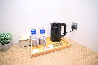 a coffeemaker sitting on a wooden table with a coffee maker at Kingston Hotel 8 - Kuala Lumpur Bukit Bintang in Kuala Lumpur