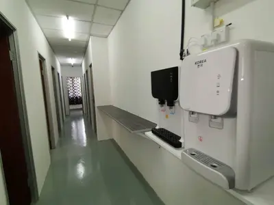 a hospital hallway with a monitor on the wall at Sri Rampai Metropolitan Hostel in Kuala Lumpur