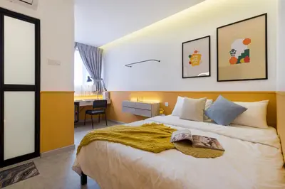a bedroom with a large bed and a desk at Upstairs Downstairs CoLiving Bukit Bintang in Kuala Lumpur