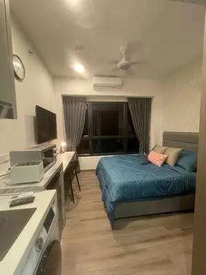 a bedroom with a bed and a desk and a television at Agile Residence TRX Bukit Bintang by Cal in Kuala Lumpur