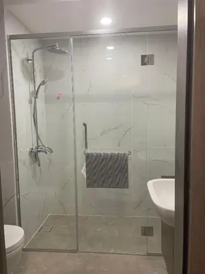 a bathroom with a glass shower with a toilet and a sink at Agile Residence TRX Bukit Bintang by Cal in Kuala Lumpur