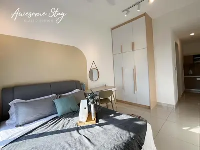 a bedroom with a large bed and a desk at Residensi Trion in Kuala Lumpur