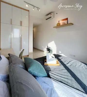 a bedroom with a large bed with blue pillows at Residensi Trion in Kuala Lumpur