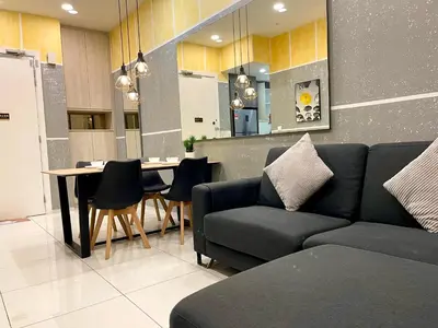 a living room with a couch and a table with chairs at The Robertson Residence in bukit bintang in Kuala Lumpur