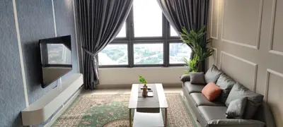 a living room with a couch and a tv at M Vertica KL 3br for 6pax by Wowhome in Kuala Lumpur