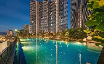 a large swimming pool in a city with tall buildings at M Vertica KL 3br for 6pax by Wowhome in Kuala Lumpur