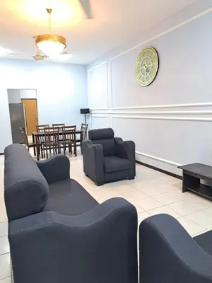 a waiting room with couches and a clock on the wall at Double-story House in Kuala Lumpur in Ampang