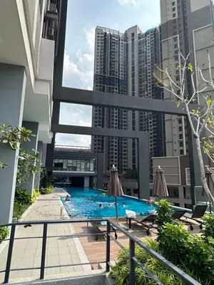 a swimming pool on the roof of a building with tall buildings at Sunway Velocity Two Deluxe in Kuala Lumpur