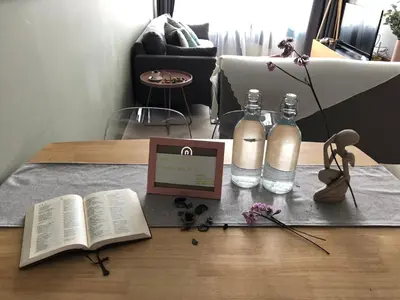 a table with an open book and two bottles of water at Sky Suites KLCC by Psalm Space exclusively for female travellers in Kuala Lumpur