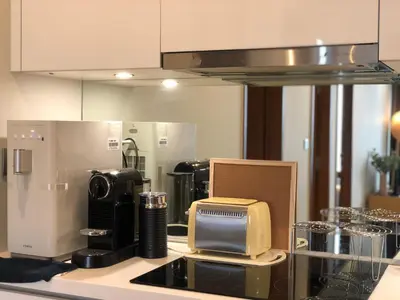 a kitchen counter with a toaster and a microwave at Sky Suites KLCC by Psalm Space exclusively for female travellers in Kuala Lumpur