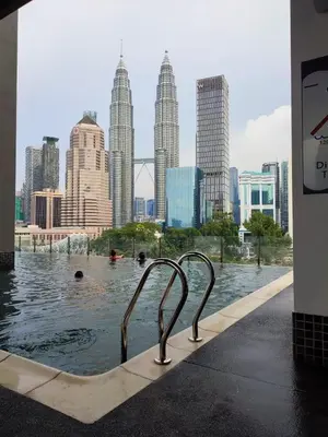 a swimming pool with a city skyline in the background at Badang Homestay KLCC in Kuala Lumpur