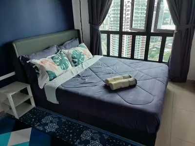 a bed with a bottle on it in a room at Badang Homestay KLCC in Kuala Lumpur