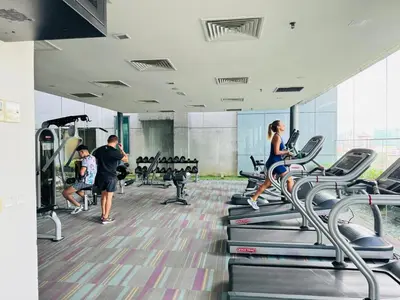 a group of people exercising on treadmills in a gym at Summer Suites Studio With Balcony Nearby KL City Centre in Kuala Lumpur