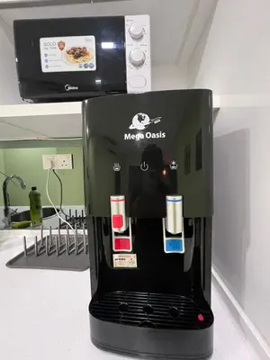 a micro oasis coffee machine sitting on top of a counter at Summer Suites Studio With Balcony Nearby KL City Centre in Kuala Lumpur