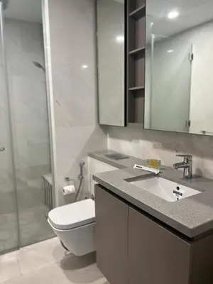 a bathroom with a toilet and a sink and a shower at Eaton Residence Suites KLCC in Kuala Lumpur