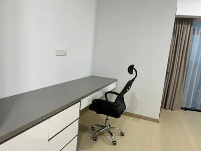 a desk with a black chair in a room at Eaton Residence Suites KLCC in Kuala Lumpur