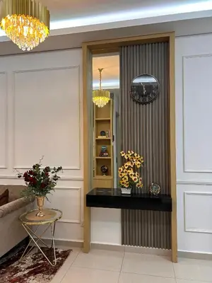 a living room with a table and a mirror at Sophia Homestay KLCC in Kuala Lumpur