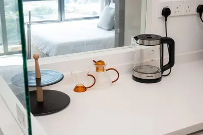 a kitchen counter with a coffee maker on a counter at Modern Design 2BR Astoria in Kuala Lumpur
