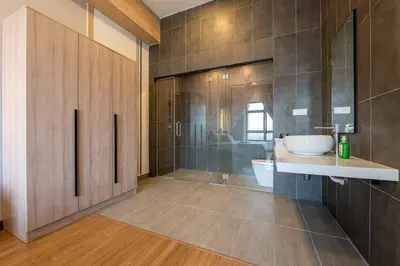 a bathroom with a sink and a toilet and a shower at Modern Design 2BR Astoria in Kuala Lumpur