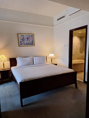 a bedroom with a large bed and a bathroom at Best Apartment Suite At Times Square KL in Kuala Lumpur
