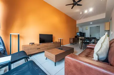 a living room with a couch and a flat screen tv at The Pano by Minsu in Kuala Lumpur